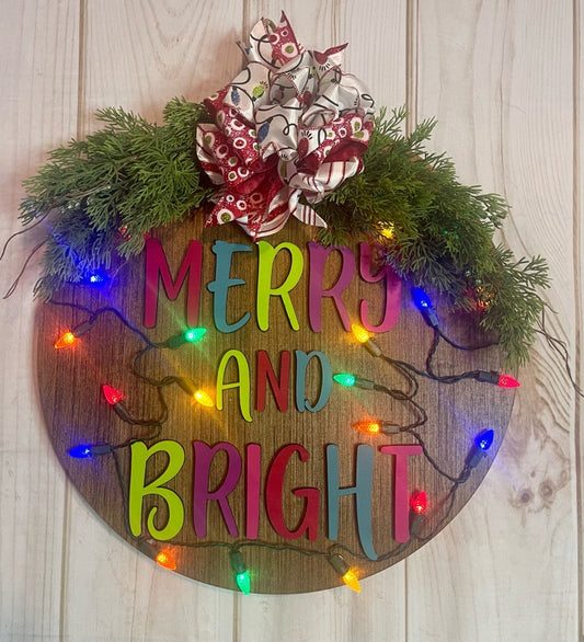 Merry  and Bright Lighted Christmas Round Wood Door Hanger with Greenery